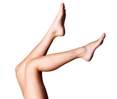Beautiful slender female legs. Photo  on grey background